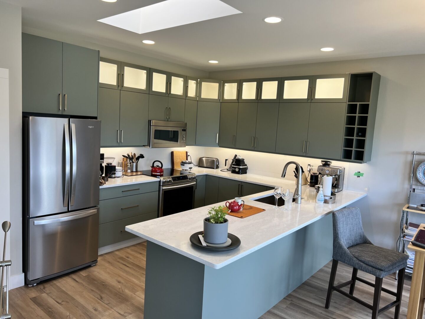 A kitchen with an island and stainless steel appliances.